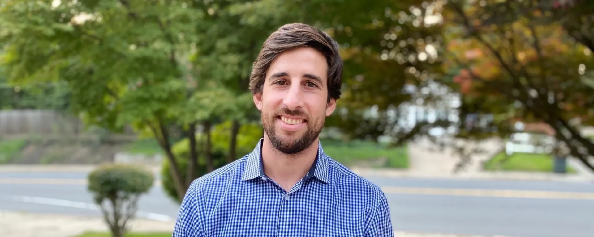 Agustín Beramendi vive hoy en Washinton DC. Agustín Beramendi mira a cámara. Detrás se ven árboles y una calle.